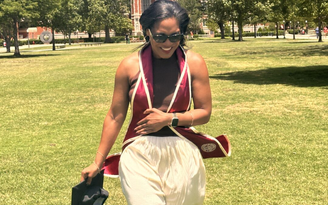Danielle standing on the lawn in front of the Bizell library at the university of Oklahoma.